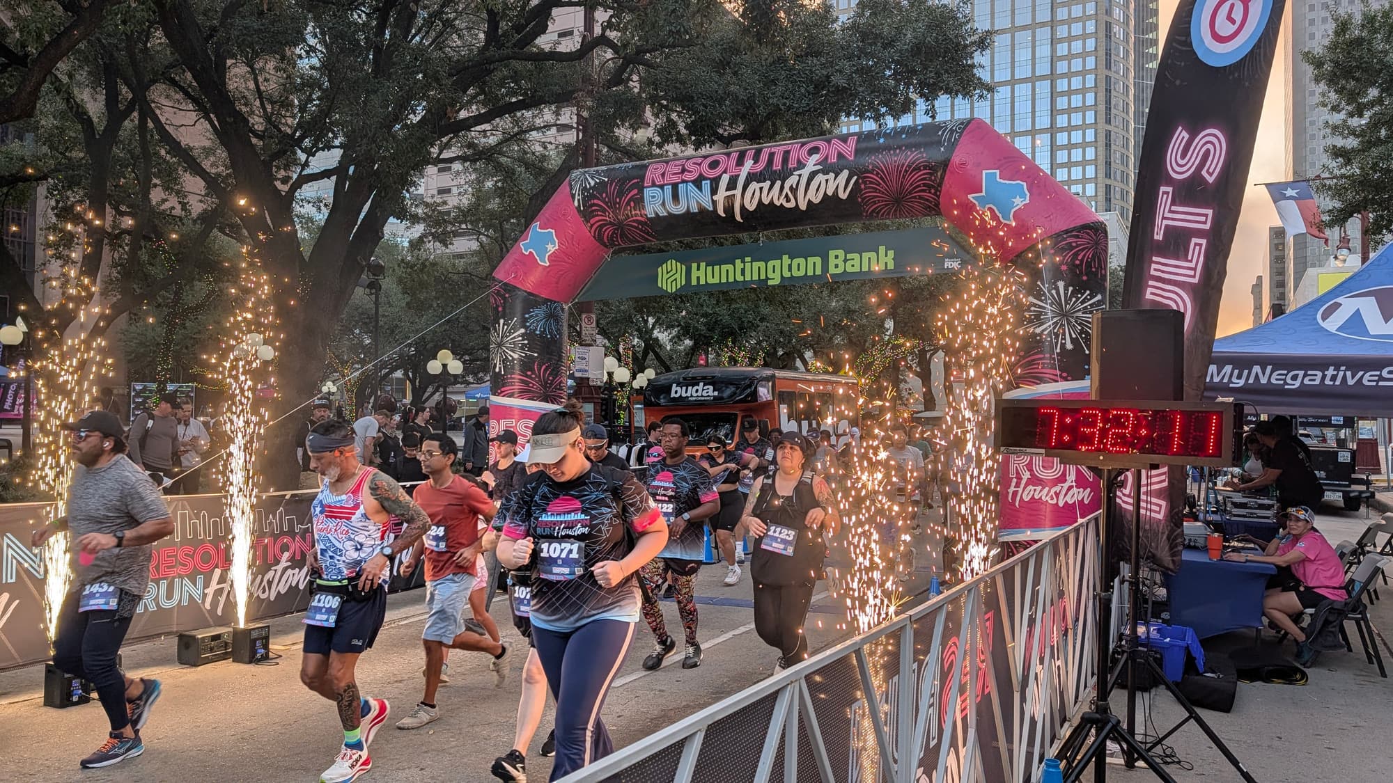 Runners starting Resolution Run Houston through sparkler fountains downtown