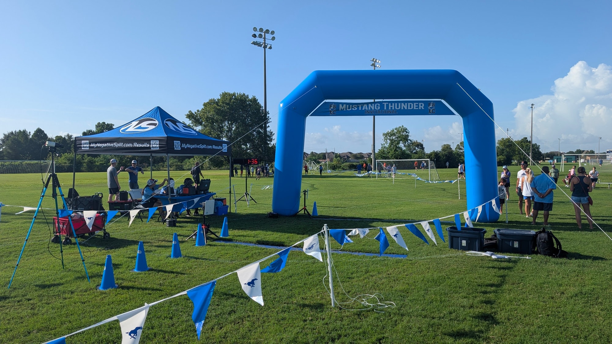 Inflatable finish arch, race clock, timing tent, and course flagging at a cross country meet