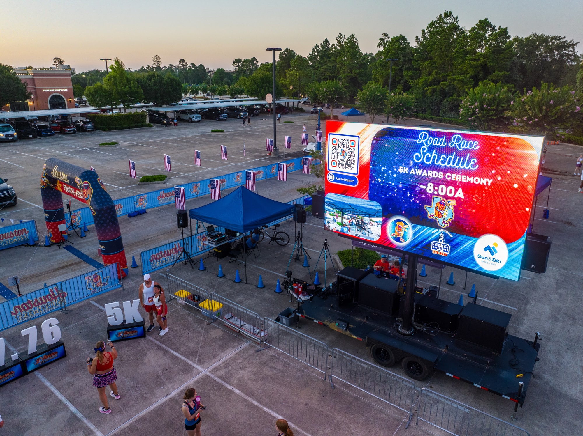 Aerial view of the screen beside a start line and festival footprint at Houston Fourth Fest